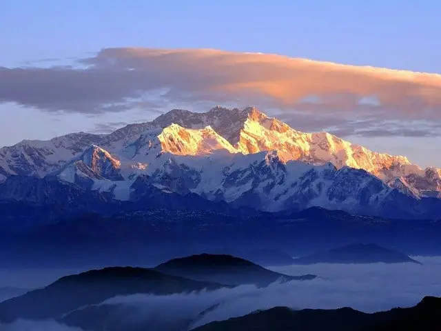 First light on the Kanchenjunga range above the cloud line