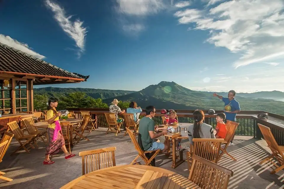 Families at a terrace café looking out over Mount Batur in Bali